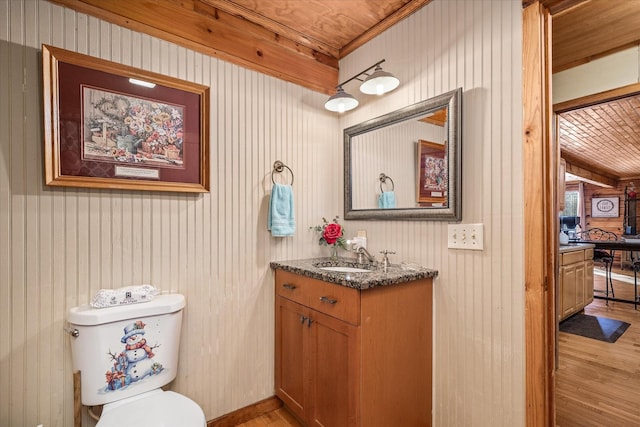 bathroom with vanity, toilet, and hardwood / wood-style floors