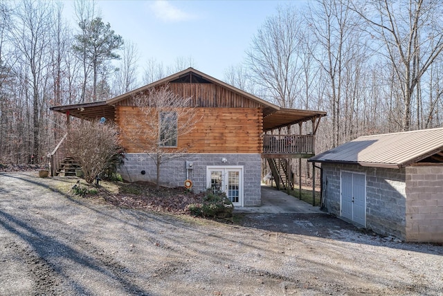 view of home's exterior with a wooden deck and french doors