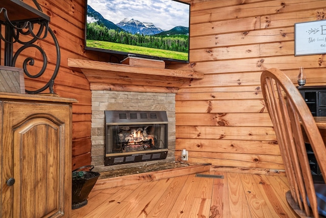 interior space featuring a fireplace and wooden walls