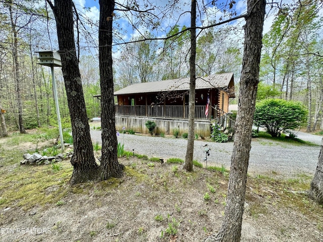 907 Parkstown Ext, Wilder, TN 38589 - exterior space featuring log exterior, a porch, and metal roof