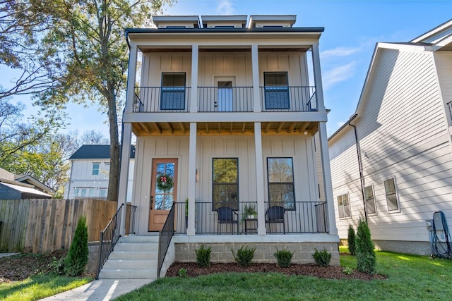 view of front of house with a balcony and covered porch