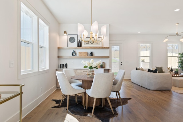 dining area with an inviting chandelier and wood-type flooring