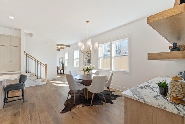 dining space featuring a notable chandelier and light hardwood / wood-style floors