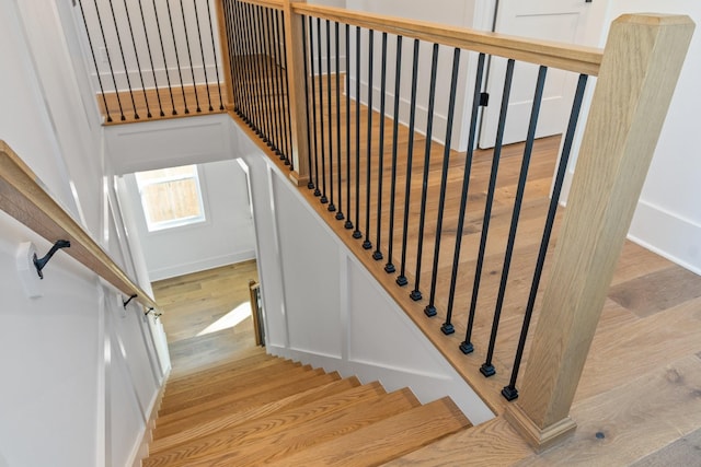 stairs featuring hardwood / wood-style floors