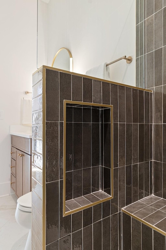 bathroom featuring a shower, vanity, and toilet