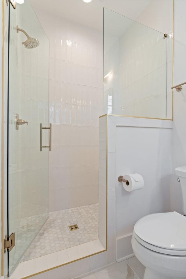 bathroom with toilet and walk in shower