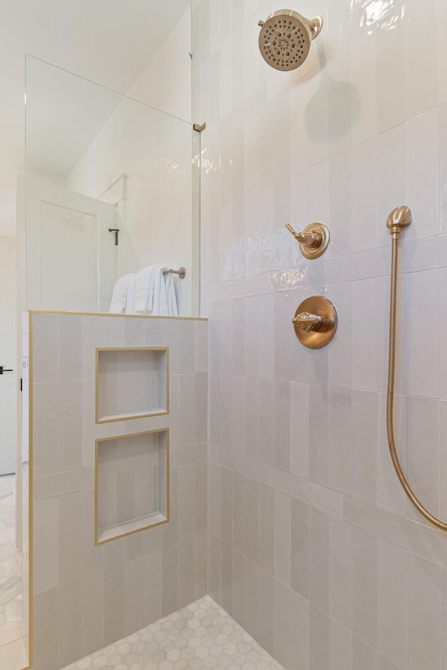 bathroom with tiled shower