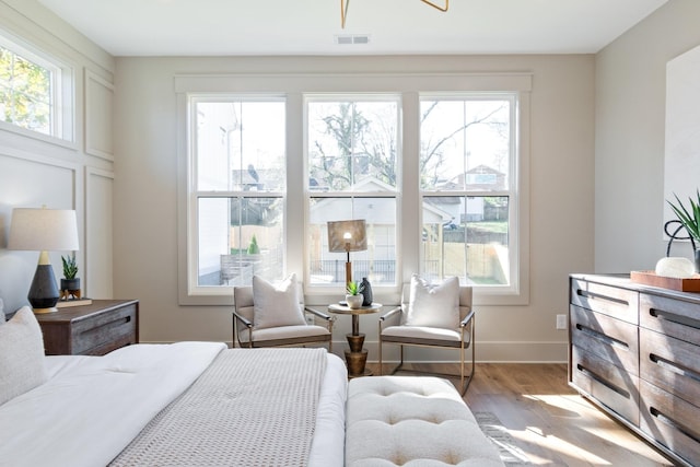 bedroom featuring multiple windows and light hardwood / wood-style floors