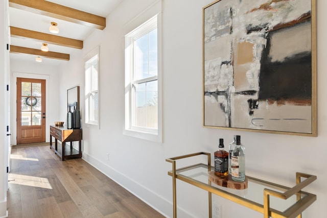 corridor with hardwood / wood-style flooring and beam ceiling