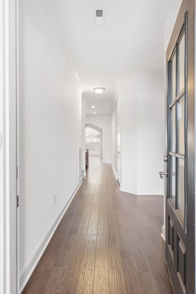 hall with ornamental molding and dark hardwood / wood-style floors