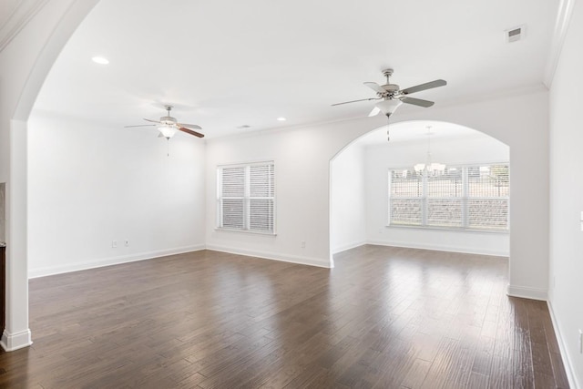 spare room featuring dark hardwood / wood-style flooring, ceiling fan with notable chandelier, and ornamental molding