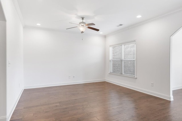 empty room with dark wood-type flooring, ceiling fan, and crown molding