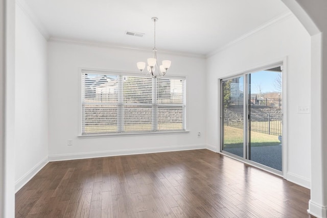 unfurnished dining area with dark hardwood / wood-style flooring, ornamental molding, and an inviting chandelier