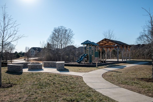 view of play area featuring a fire pit and a lawn