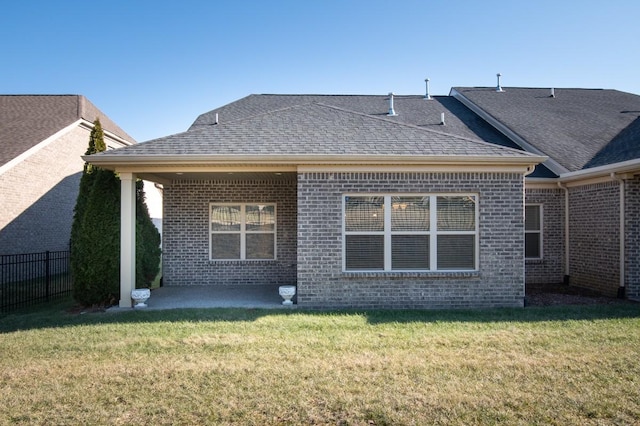 back of house with a lawn and a patio area