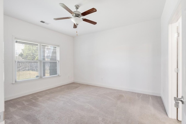 empty room with ceiling fan and light colored carpet