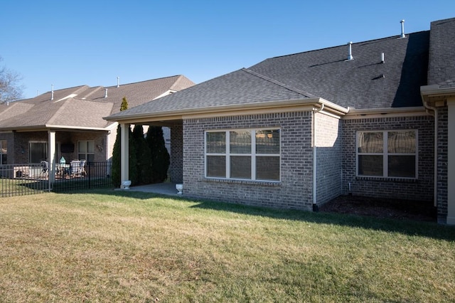 back of house with a lawn and a patio area