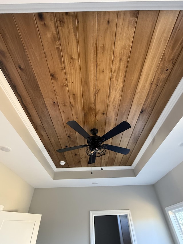 details with wooden ceiling and a raised ceiling