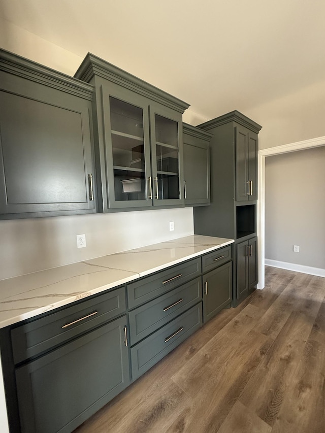 bar featuring dark wood-style flooring and baseboards