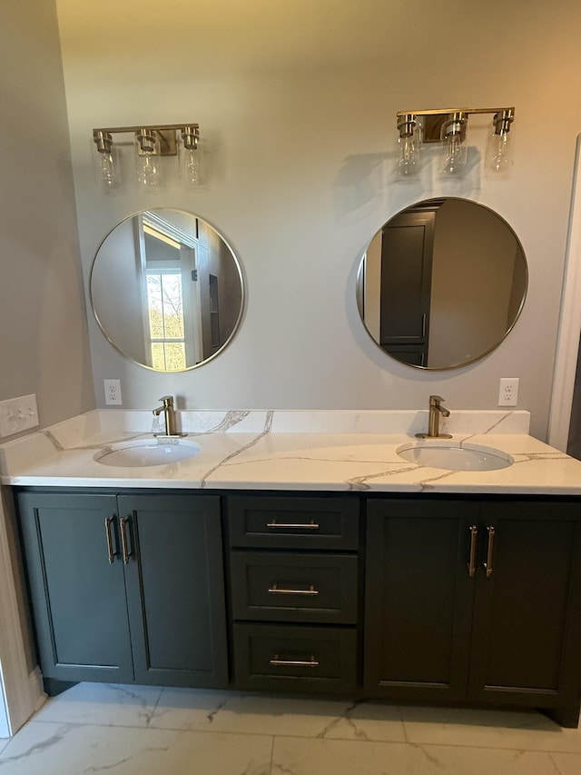 bathroom featuring double vanity, marble finish floor, and a sink