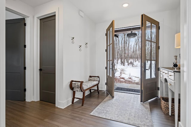 foyer with dark hardwood / wood-style floors and french doors