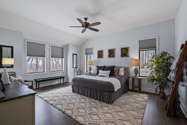 bedroom featuring multiple windows, hardwood / wood-style floors, vaulted ceiling, and ceiling fan