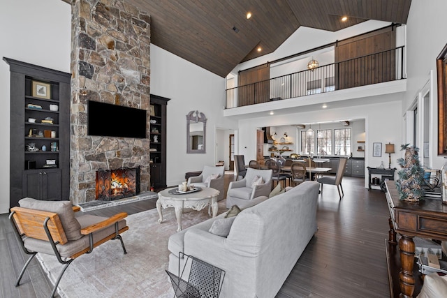 living room featuring high vaulted ceiling, a fireplace, wooden ceiling, and wood-type flooring