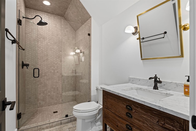 bathroom featuring walk in shower, vanity, and toilet