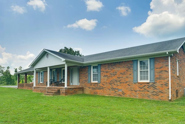 ranch-style home with a front lawn, crawl space, brick siding, and covered porch