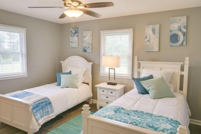 bedroom with dark hardwood / wood-style floors and ceiling fan