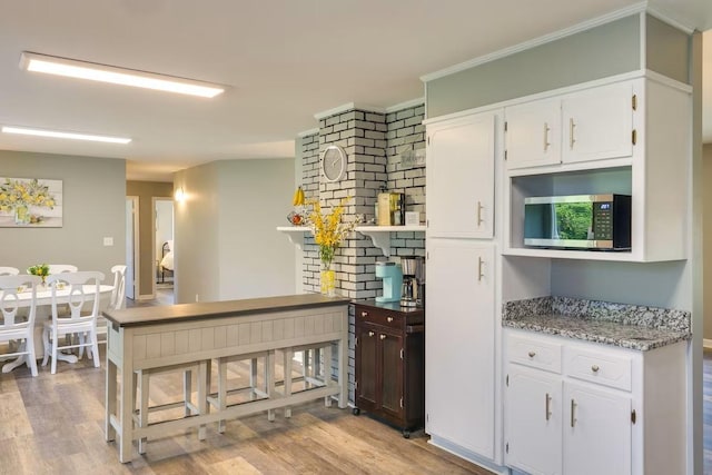 kitchen featuring light hardwood / wood-style floors and white cabinets