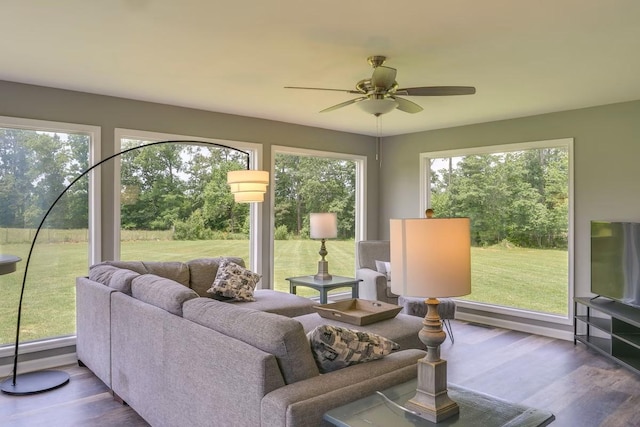 sunroom / solarium featuring ceiling fan