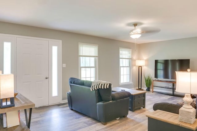 living room featuring ceiling fan and light hardwood / wood-style floors