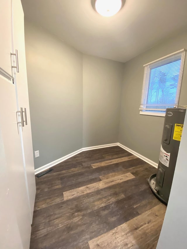 utility room featuring water heater and visible vents