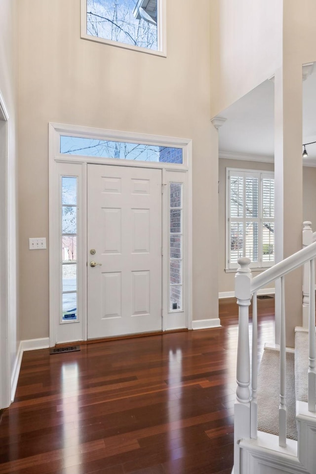 entrance foyer featuring dark wood-type flooring and a high ceiling