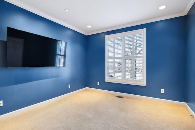 spare room featuring crown molding, carpet floors, and a wealth of natural light