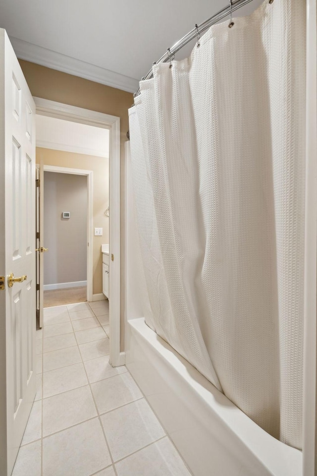 bathroom with crown molding, tile patterned floors, and shower / tub combo