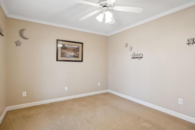 carpeted empty room featuring ceiling fan and ornamental molding