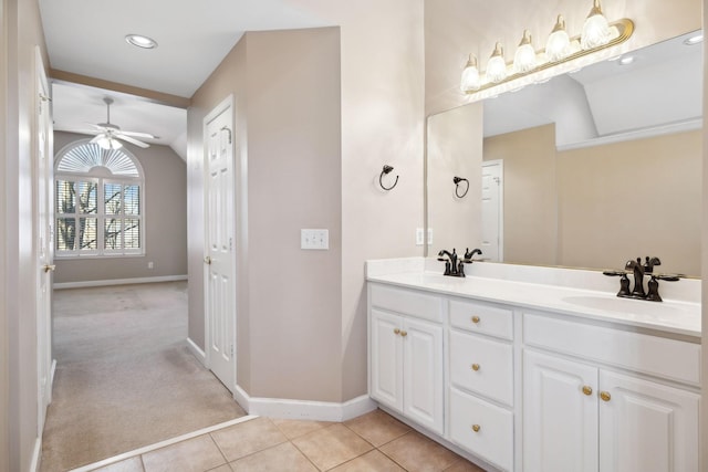 bathroom featuring tile patterned flooring, vanity, lofted ceiling, and ceiling fan