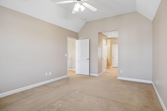 unfurnished bedroom featuring lofted ceiling, light carpet, and ceiling fan