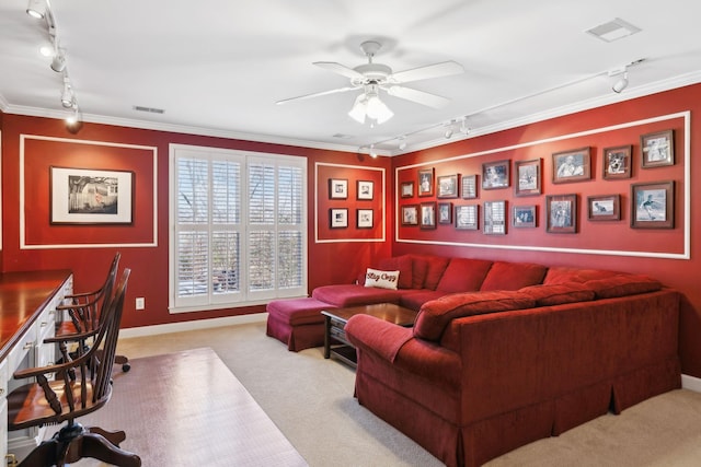 carpeted living room featuring ornamental molding, rail lighting, and ceiling fan