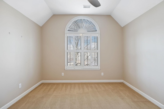 unfurnished room with lofted ceiling, light colored carpet, and ceiling fan