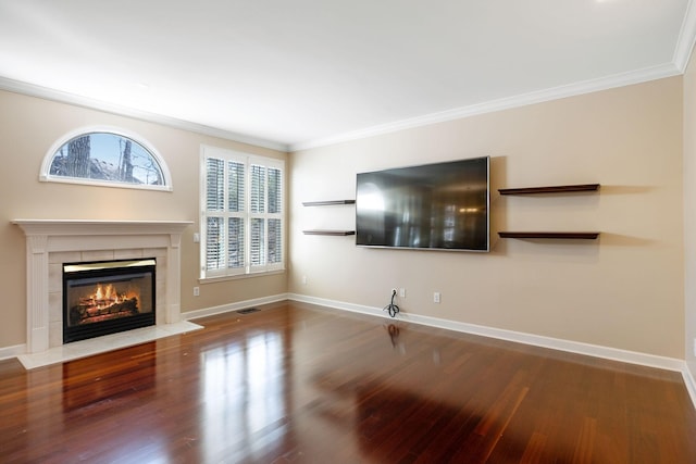 unfurnished living room featuring wood-type flooring, ornamental molding, and a fireplace