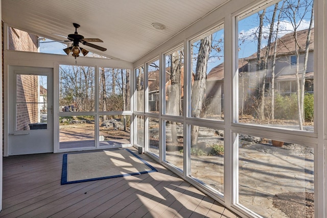 unfurnished sunroom with ceiling fan and vaulted ceiling