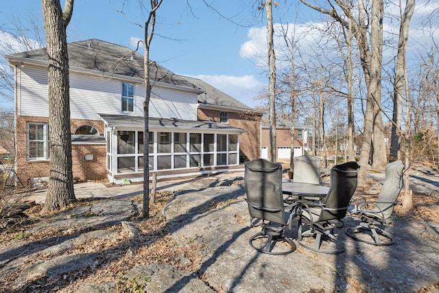 back of property with a sunroom