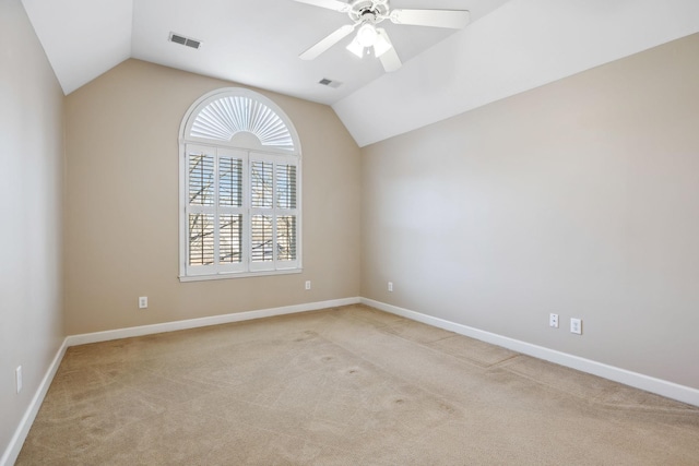 carpeted spare room with ceiling fan and lofted ceiling