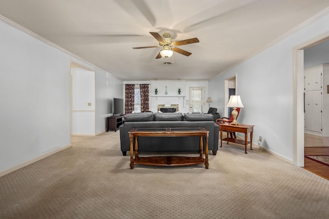 carpeted living room with crown molding, ceiling fan, and a brick fireplace