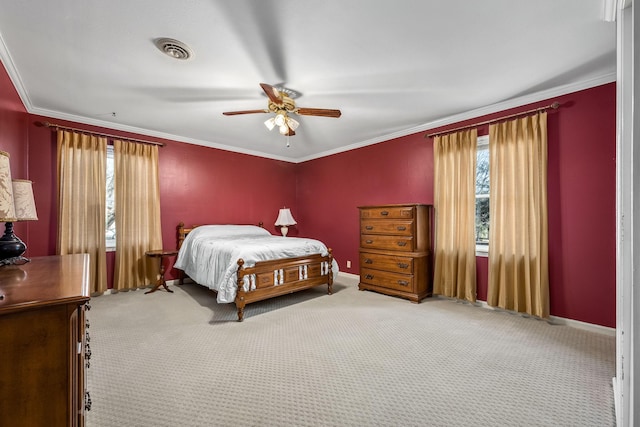 carpeted bedroom with ceiling fan and ornamental molding