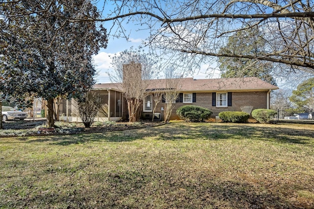 ranch-style house with a sunroom and a front lawn