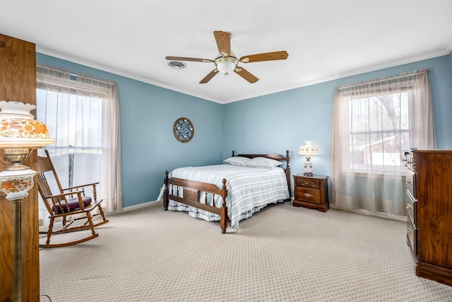 bedroom featuring multiple windows, crown molding, carpet floors, and ceiling fan